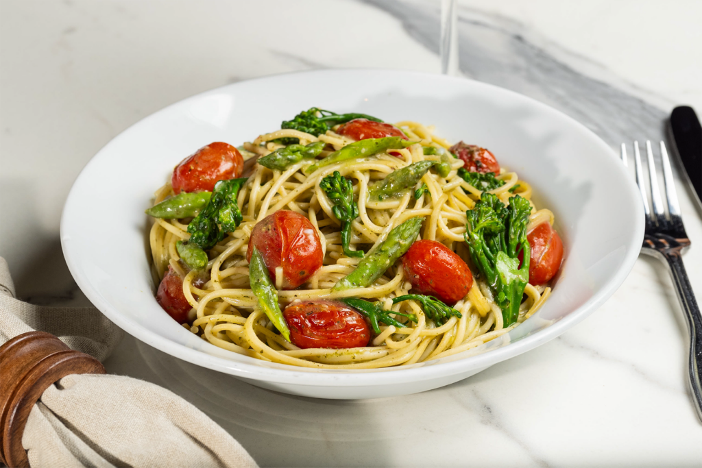 Pesto spaghetti with tomatoes, asparagus and broccolini.